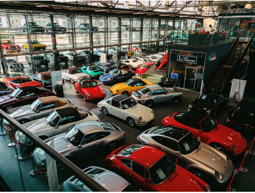New cars parked at a dealership showroom.