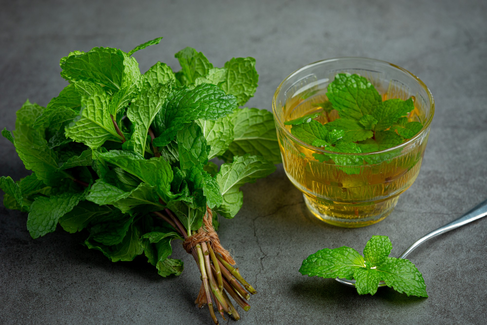 Mint tea in a glass, ready to drink.