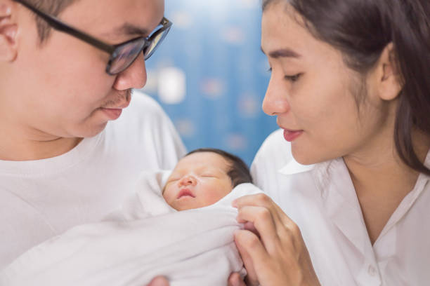 Parents holding their newborn baby.