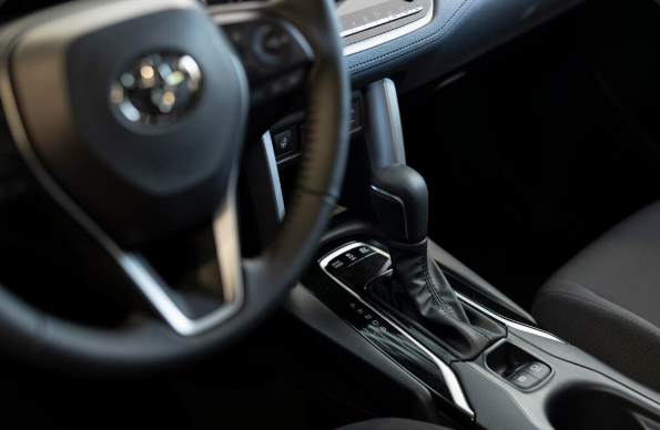 Close-up of a car’s automatic gear shift lever and centre console.