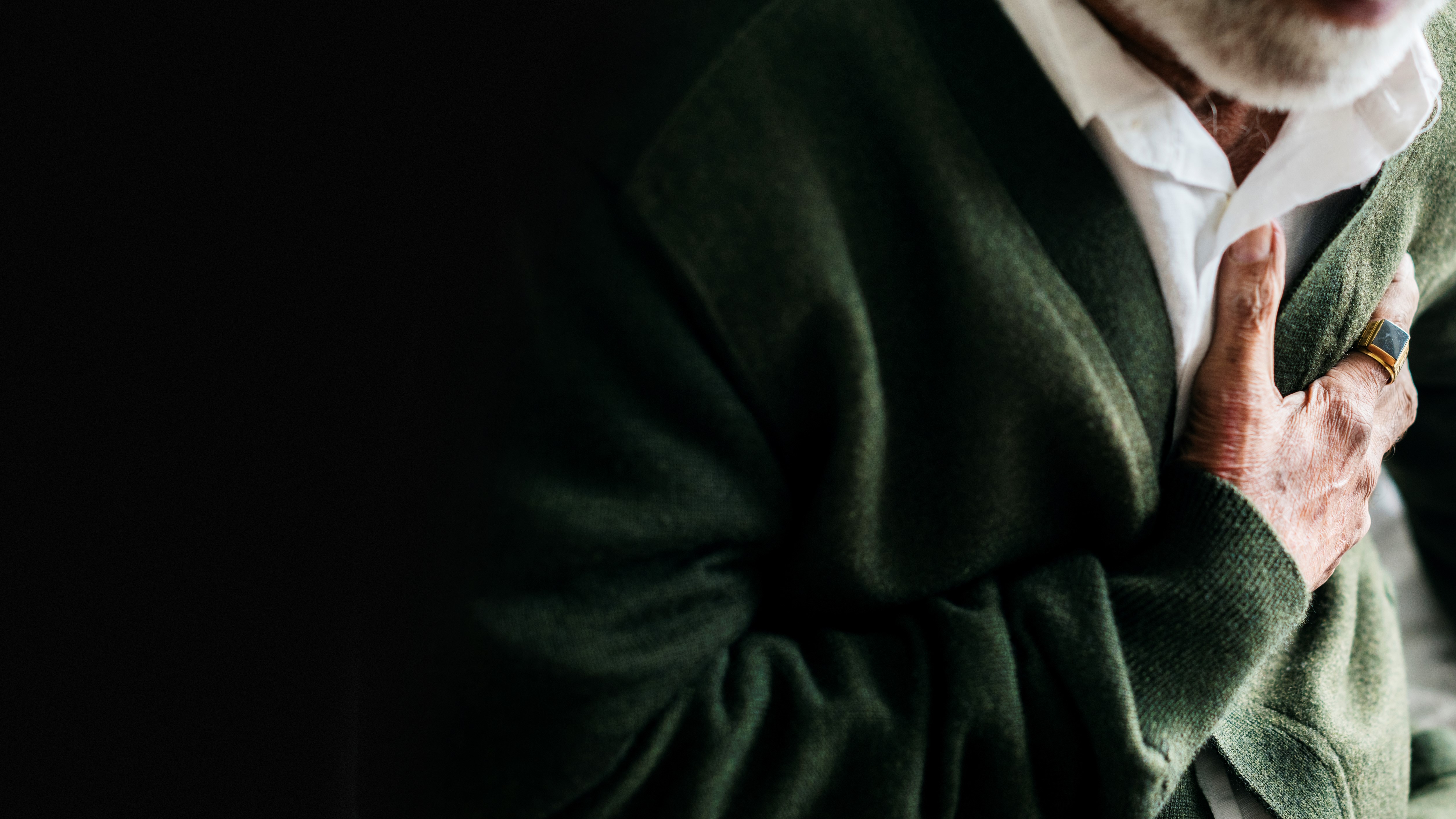 A person clenching their chest in pain.