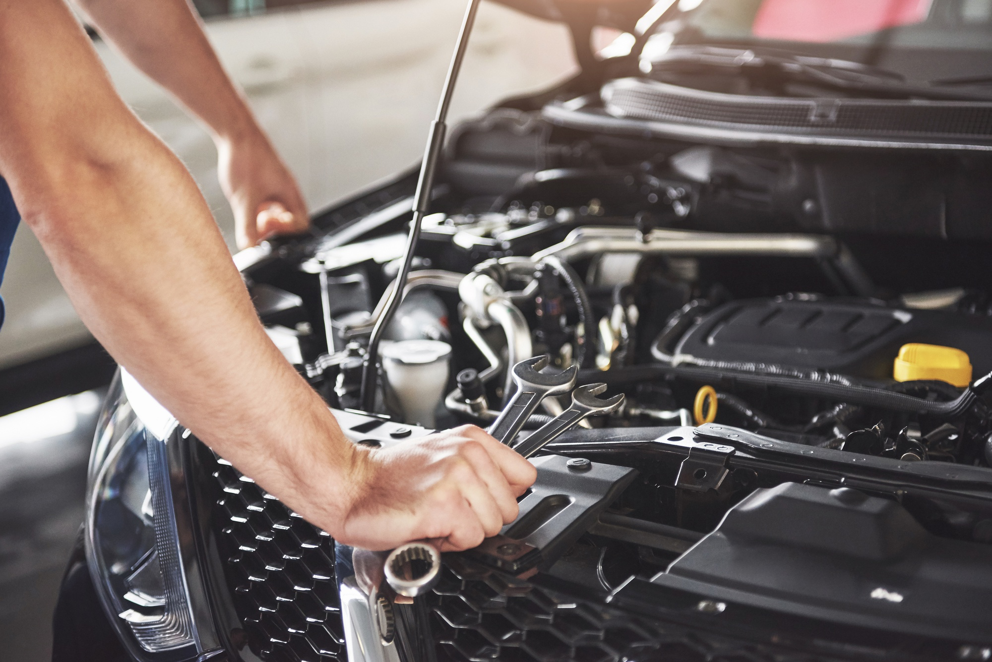 A mechanic inspecting a car engine.