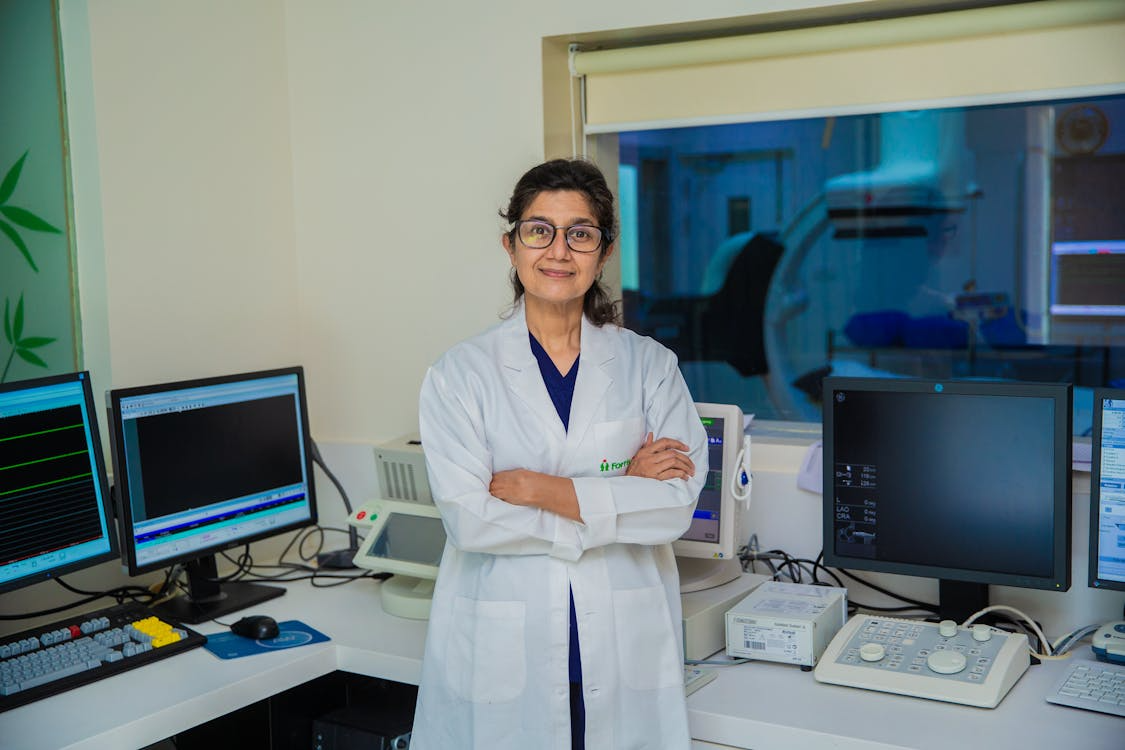 A doctor standing with her arms crossed.