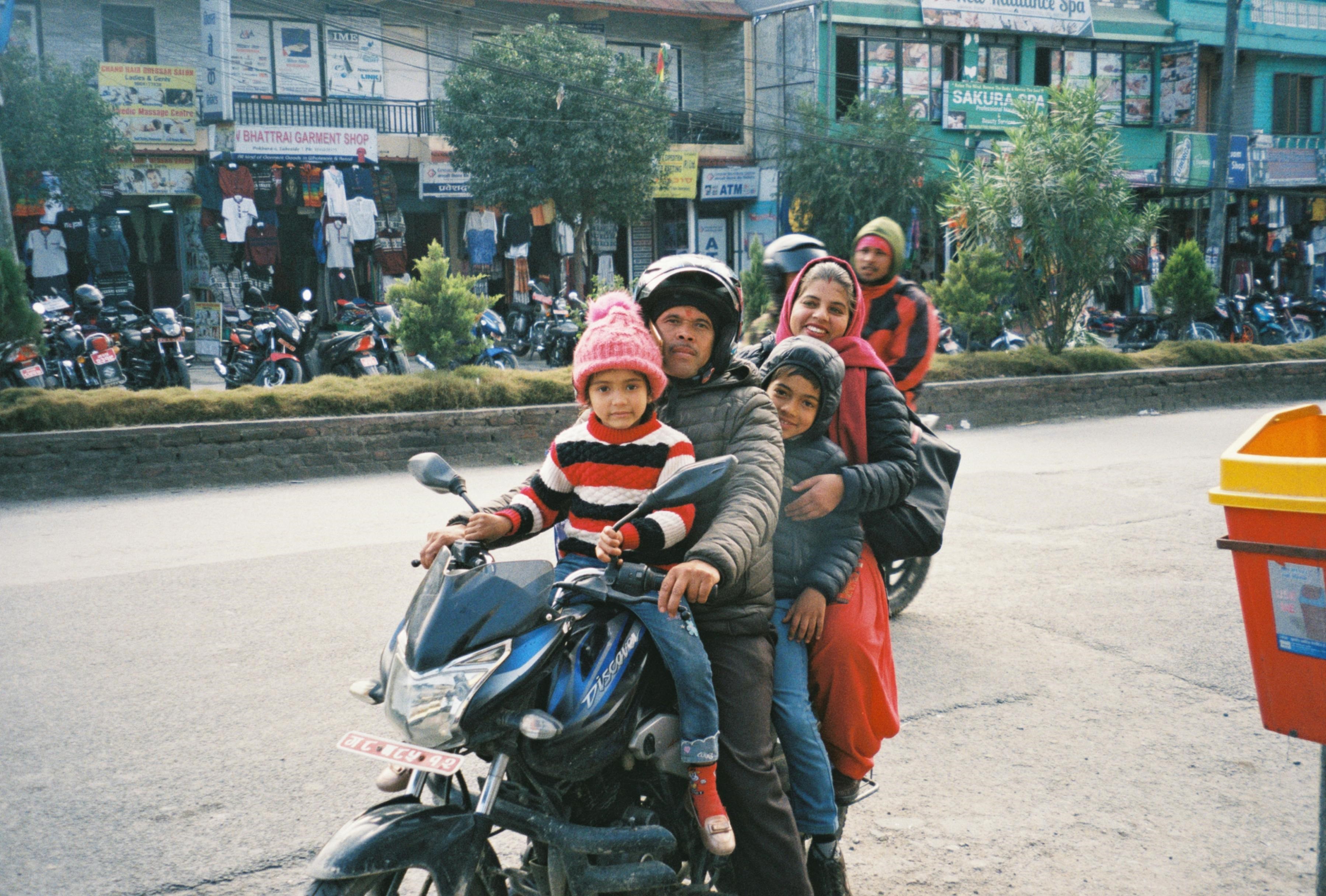 A family riding on a motorcycle.
