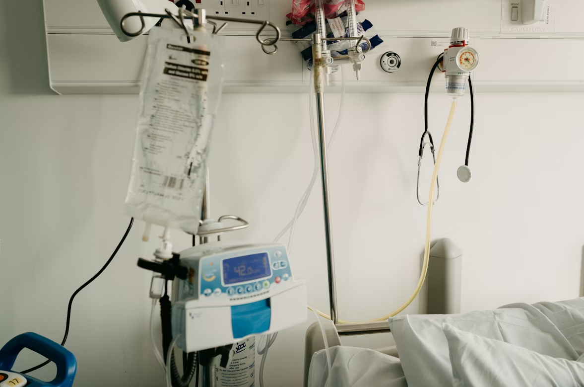 A hospital bed with medical equipment setup.