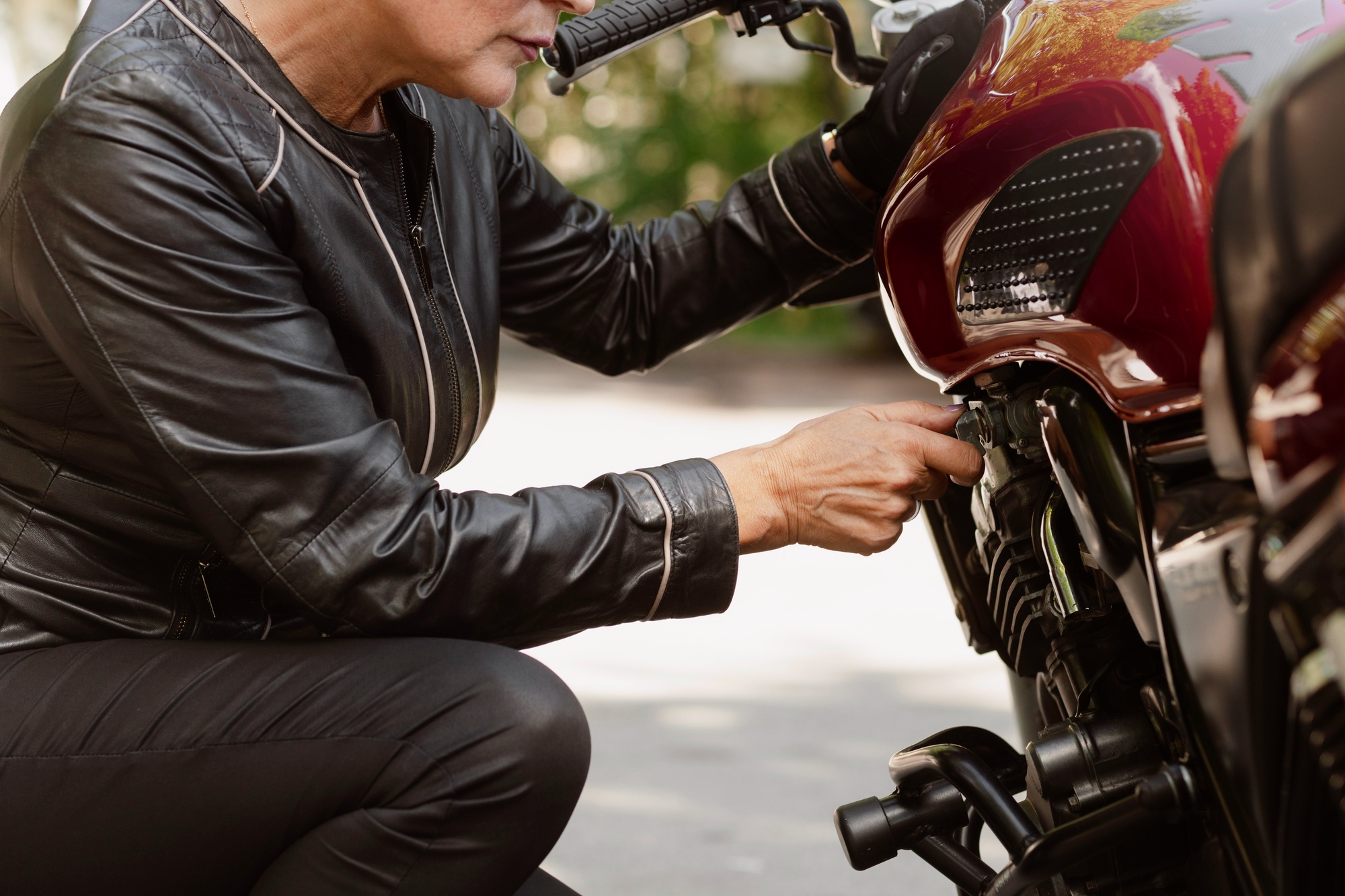 A woman is seen using a bike puncture repair kit.