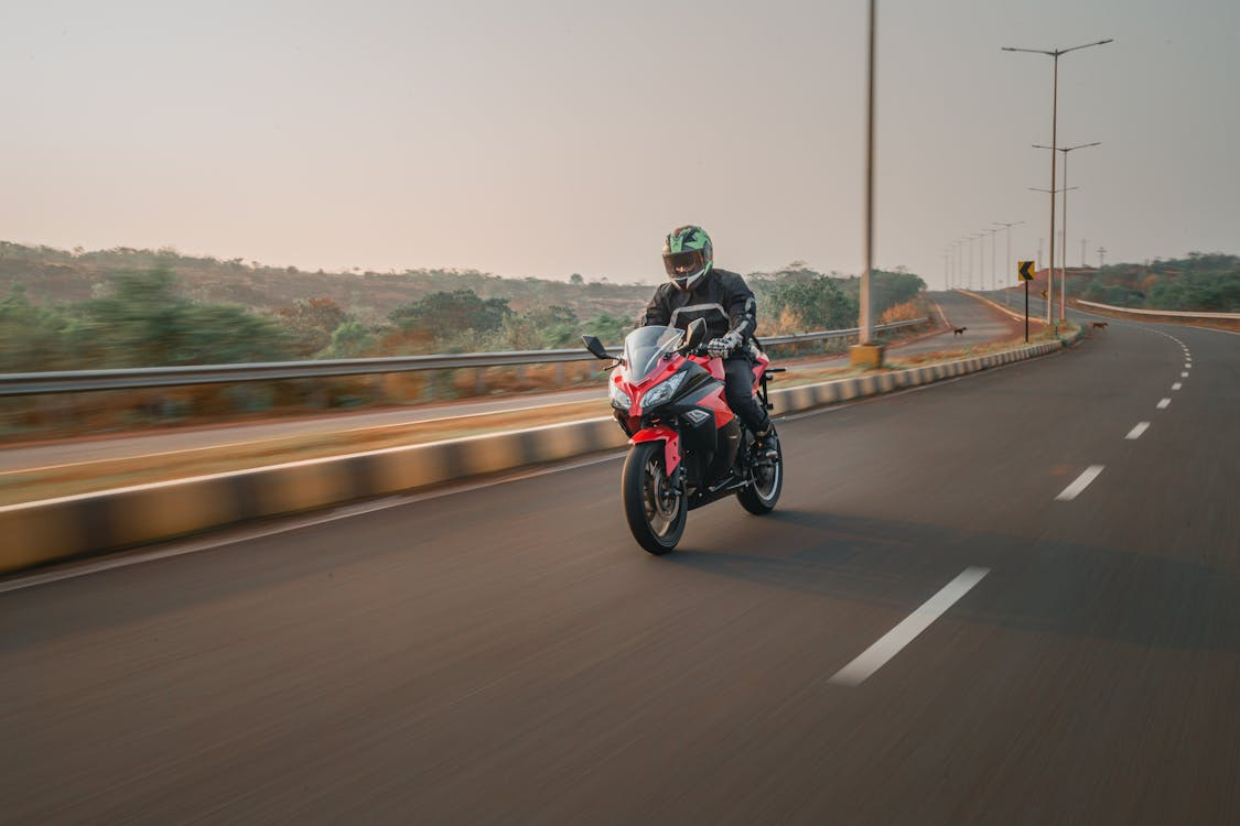 A man riding a motorcycle on a road.