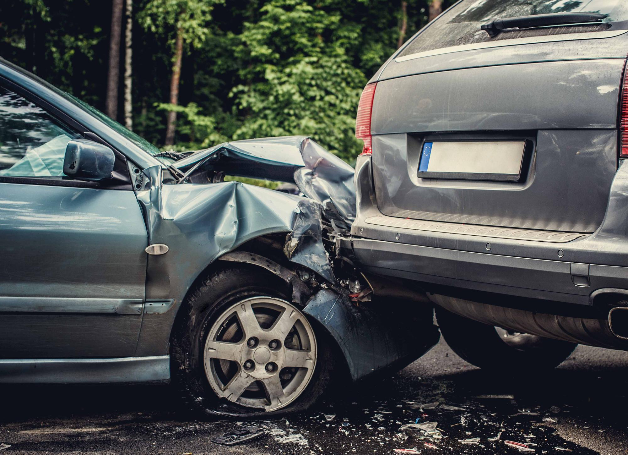 A severely damaged car after a head-on collision, highlighting the importance of Compulsory Personal Accident cover for driver protection.